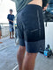 Man wearing blue boardshorts on a boat